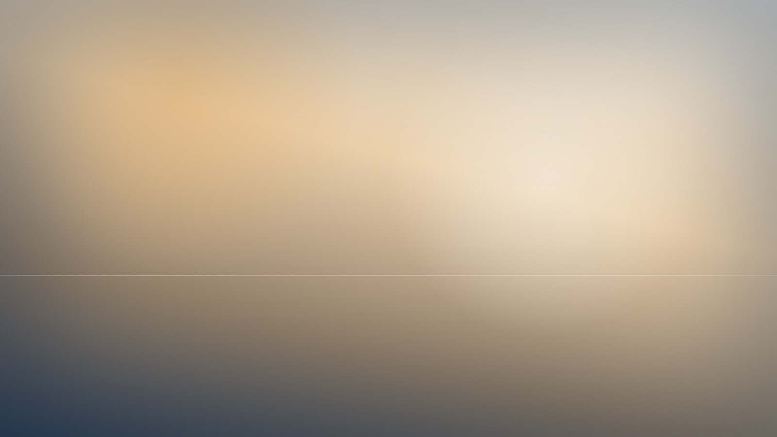 A broad expanse of soft, even colour beneath a still and quiet sky.